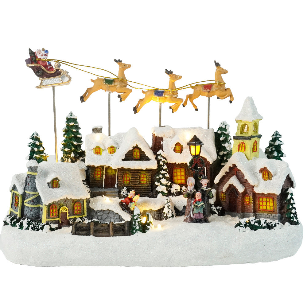 Christmas village scene with houses, trees, and Santa Claus on a white background