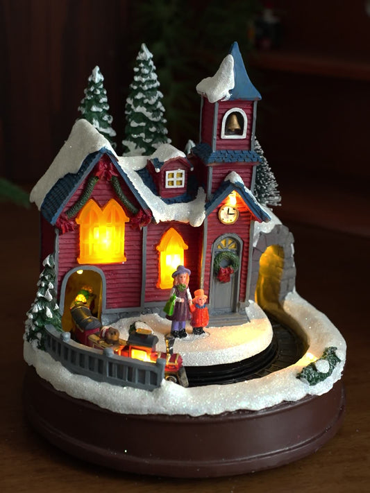 Decorative Christmas scene with a house, trees, and people on a dark background