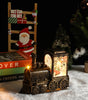 Decorative metallic train lamp with Christmas-themed items including a Santa figure and gift box.
