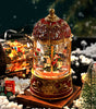 Decorative Christmas snow globe with Santa Claus and reindeer on a snowy background