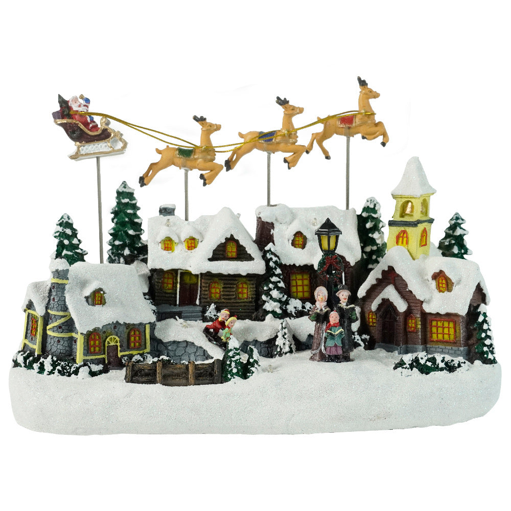 Christmas village scene with Santa's sleigh, houses, and people on a white background