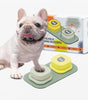 Dog standing on a step stool with training buttons in front of its packaging.
