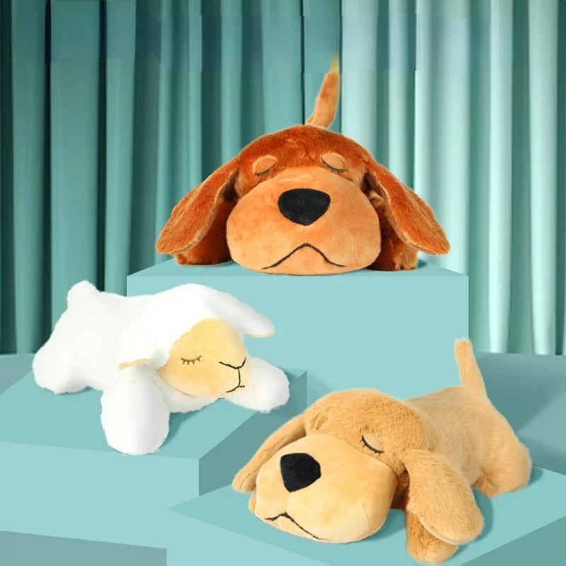 Two plush dogs and a sheep on a teal platform with a teal curtain background