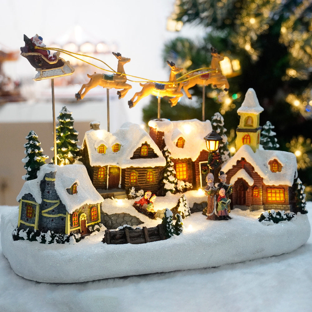 Decorative Christmas village scene with houses, trees, and Santa in a sleigh.