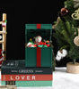 Decorative Christmas scene with a snowman in a box, Santa Claus figure, and Christmas tree.