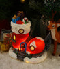 Decorative Christmas scene with a lit-up boot filled with gifts, a reindeer, and presents on a snowy surface.