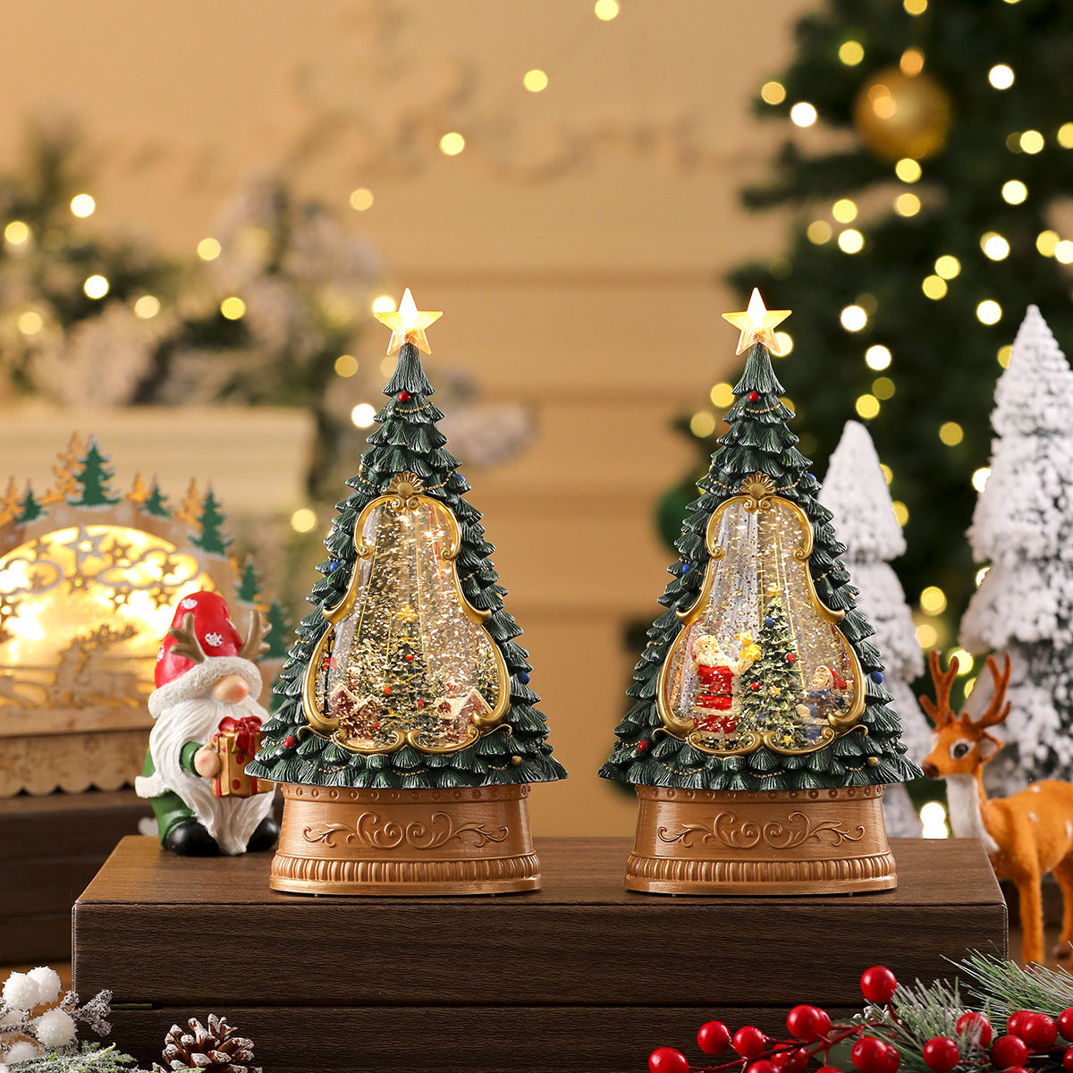Two decorative Christmas tree figurines on a wooden stand with festive background.