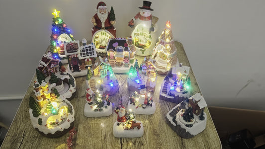 Collection of small, illuminated decorative items on a wooden table.