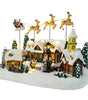 Christmas village scene with houses, trees, and Santa Claus on a white background