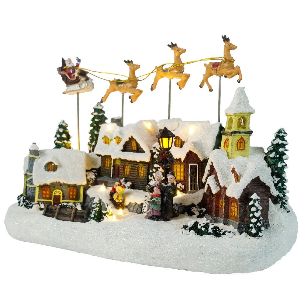 Christmas village scene with houses, trees, and Santa Claus on a white background