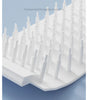 White plastic grid with small spikes on a blue background