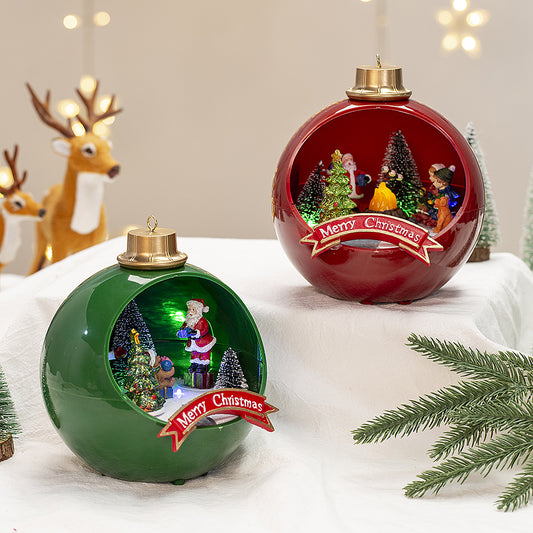 Two Christmas-themed ball ornaments with Santa Claus and trees on a snowy surface.