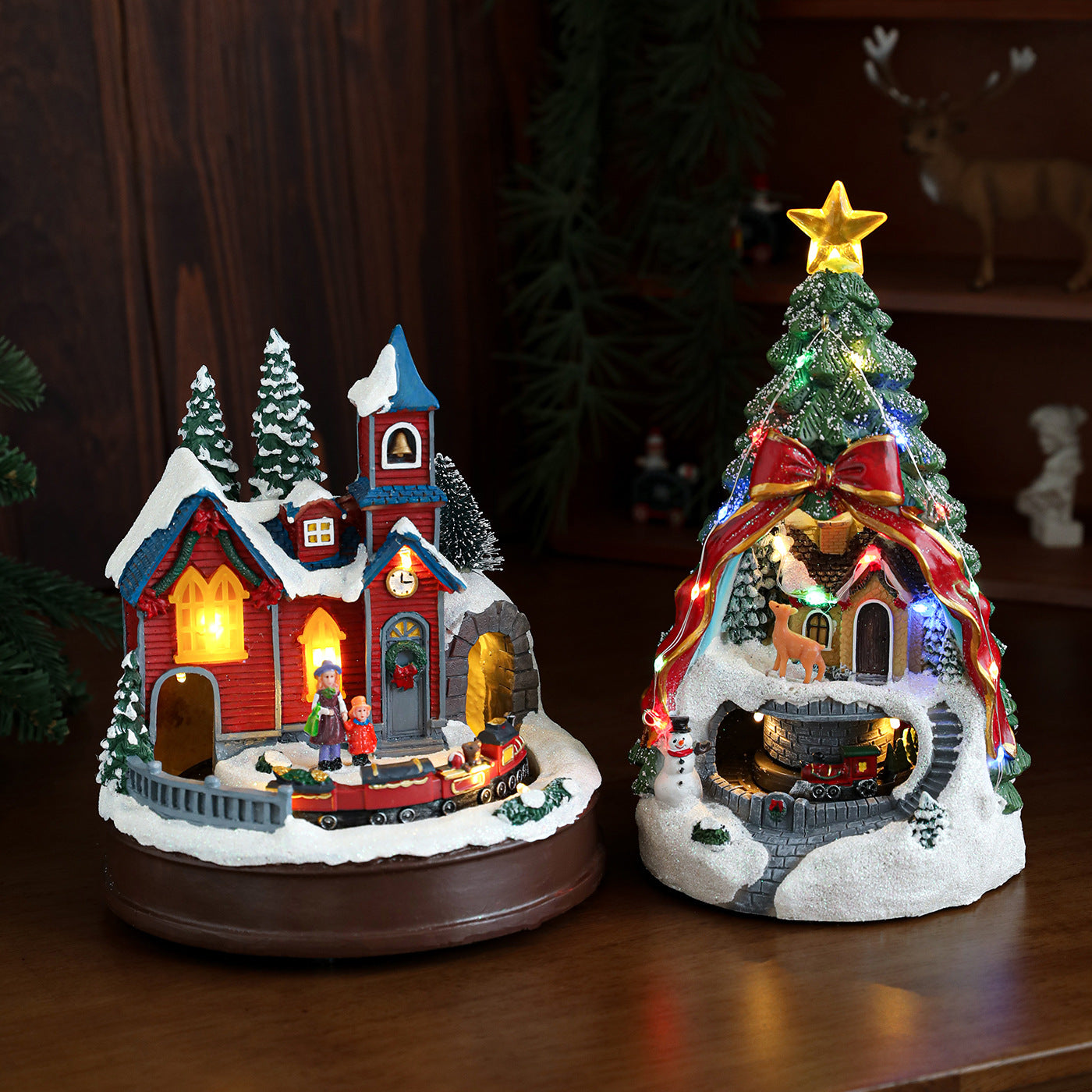 Two Christmas-themed decorative lights on a wooden surface with a dark background.