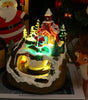 Decorative Christmas scene with a lit-up house, trees, and Santa Claus figure.