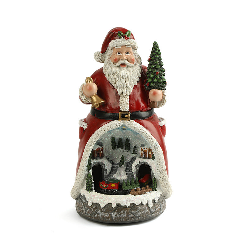 Decorative figurine of Santa Claus with a small village scene inside, on a white background.