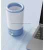 Blue and white pet paw cleaner on a light blue surface next to an open laptop.