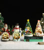 Decorative Christmas snow globes on a snowy surface with a dark background