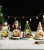 Set of Christmas-themed decorative figurines with lights on a snowy background
