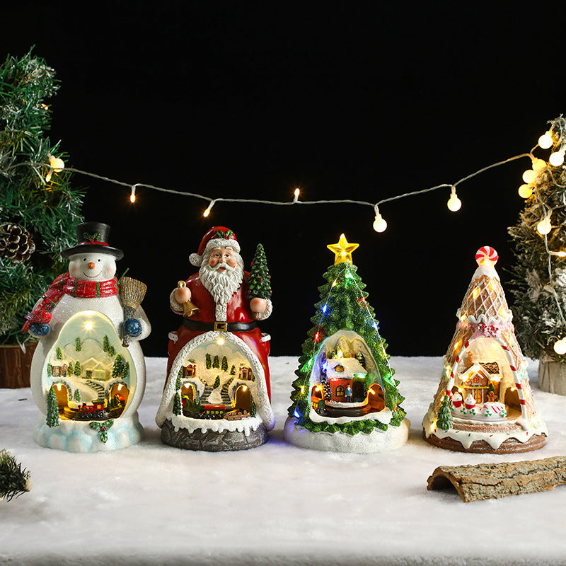 Set of Christmas-themed decorative figurines with lights on a snowy background