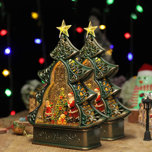 Decorative Christmas tree figurine with Santa Claus and snowmen inside, on a wooden surface with blurred lights in the background.
