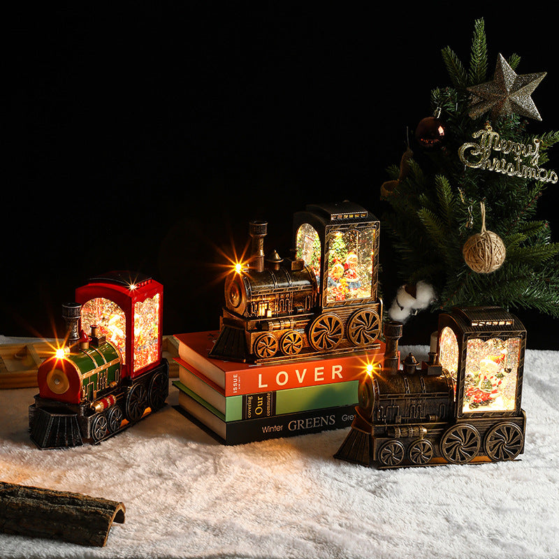 Decorative train set with lights on books next to a Christmas tree.