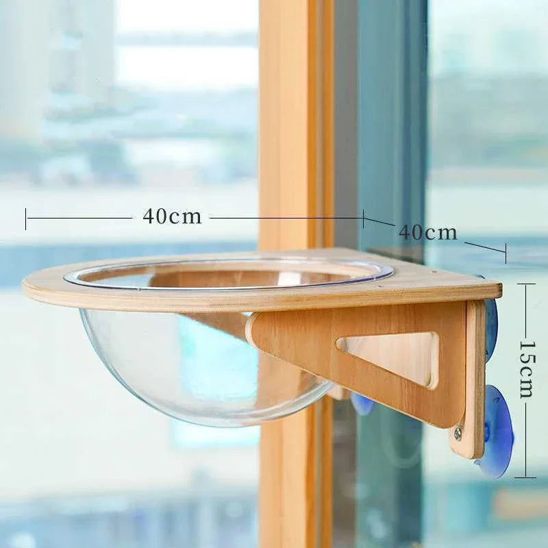 Wooden pet feeding station with glass bowl, measurements indicated, against a blurred window background.